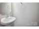 Modern powder room with a white basin sink, chrome faucet and light gray walls at 11530 Galashiels Dr, Huntersville, NC 28078