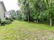 Home's back exterior featuring a large yard with a grassy lawn at 11647 Baystone Pl, Concord, NC 28025