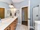 Bright bathroom featuring double sink vanity, tile flooring, and glass door shower at 11647 Baystone Pl, Concord, NC 28025