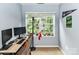 Bedroom with desk, computer, and bright window with backyard view at 11647 Baystone Pl, Concord, NC 28025