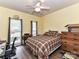 Bedroom with yellow walls, ceiling fan, and two bright windows with a backyard view at 11647 Baystone Pl, Concord, NC 28025