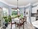 Bright breakfast nook with bay windows, tile flooring, and a cozy dining set at 11647 Baystone Pl, Concord, NC 28025