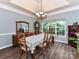 Formal dining room with hardwood floors, crown molding, a large window, and a decorative hutch at 11647 Baystone Pl, Concord, NC 28025
