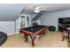 Spacious game room with pool table, overhead fan, and adjacent sitting area at 11647 Baystone Pl, Concord, NC 28025