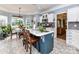 Open kitchen with island, white cabinets, stainless appliances, eat-in breakfast nook, and tile flooring at 11647 Baystone Pl, Concord, NC 28025