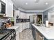Modern kitchen featuring quartz countertops, stainless appliances, tile backsplash, and center island at 11647 Baystone Pl, Concord, NC 28025