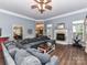 Cozy living room with a fireplace, ceiling fan, and a large sectional sofa at 11647 Baystone Pl, Concord, NC 28025