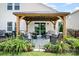 Beautiful backyard featuring a covered patio with comfortable seating and lush landscaping at 1244 Tranquil Falls Ln, Matthews, NC 28104