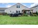 Spacious backyard with a covered patio, grill area, and well-maintained lawn, perfect for outdoor activities at 1244 Tranquil Falls Ln, Matthews, NC 28104