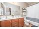 Bathroom with double sinks, wood cabinets, a mirror, and a toilet with a shower/tub combination at 1244 Tranquil Falls Ln, Matthews, NC 28104