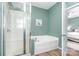Bathroom featuring shower, garden tub, and hardwood floors at 1244 Tranquil Falls Ln, Matthews, NC 28104