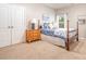Comfortable bedroom with carpet, window, queen bed and wood furniture at 1244 Tranquil Falls Ln, Matthews, NC 28104