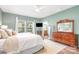 Comfortable bedroom with ample natural light, hardwood floors, and an ensuite bathroom at 1244 Tranquil Falls Ln, Matthews, NC 28104