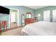 Bedroom with hardwood floors and ensuite bathroom is painted in soft green color at 1244 Tranquil Falls Ln, Matthews, NC 28104