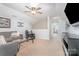 Lofted bonus room with two couches, chair, carpet and view to other rooms at 1244 Tranquil Falls Ln, Matthews, NC 28104