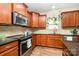 Modern kitchen with stainless steel appliances and granite countertops at 1244 Tranquil Falls Ln, Matthews, NC 28104
