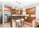 Kitchen boasts stainless steel appliances, dark granite, and wood cabinets at 1244 Tranquil Falls Ln, Matthews, NC 28104