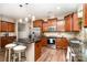 Kitchen featuring an island with bar seating, stainless appliances, and ample cabinetry at 1244 Tranquil Falls Ln, Matthews, NC 28104
