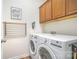 Bright laundry room featuring modern appliances and built in storage at 1244 Tranquil Falls Ln, Matthews, NC 28104