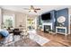 Cozy living room features a fireplace, hardwood floors, and sliding doors to the backyard at 1244 Tranquil Falls Ln, Matthews, NC 28104