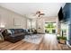 Bright living room with hardwood floors, a dark fireplace, and a leather couch at 1244 Tranquil Falls Ln, Matthews, NC 28104