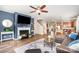 Inviting living room with a fireplace, ceiling fan, hardwood floors, and an open floor plan at 1244 Tranquil Falls Ln, Matthews, NC 28104