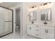 Bright bathroom featuring double vanity, modern fixtures, and glass-enclosed shower at 12744 Susanna Dr, Charlotte, NC 28214