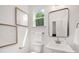 Bathroom featuring an elegant vanity with a pedestal sink, modern fixtures, and framed artwork at 12744 Susanna Dr, Charlotte, NC 28214