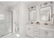 Bright bathroom featuring double sink vanity with modern fixtures and glass-enclosed shower at 12744 Susanna Dr, Charlotte, NC 28214