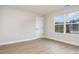 Bedroom with wood-look floors and a window offering neighborhood views at 12744 Susanna Dr, Charlotte, NC 28214