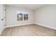 Bedroom with natural light, wood-look floors, and a view of the neighborhood at 12744 Susanna Dr, Charlotte, NC 28214