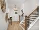 Inviting entryway with modern light fixture, stylish decor, wood-look floors, and staircase at 12744 Susanna Dr, Charlotte, NC 28214