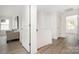 Bright hallway with wood-look floors leading to other rooms and a comfortable sitting area at 12744 Susanna Dr, Charlotte, NC 28214