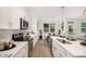 Well-lit eat-in kitchen with stainless appliances and quartz countertops at 12744 Susanna Dr, Charlotte, NC 28214