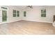 Spacious living room featuring an exterior door, many windows for ample natural light and wood flooring at 12744 Susanna Dr, Charlotte, NC 28214