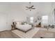 Bright main bedroom with ceiling fan, ensuite bathroom, and multiple windows at 12744 Susanna Dr, Charlotte, NC 28214