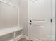 Mudroom featuring built in storage and shelves next to an exterior door at 12744 Susanna Dr, Charlotte, NC 28214