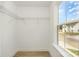Spacious walk-in closet featuring wire shelving and natural light from a window at 12744 Susanna Dr, Charlotte, NC 28214