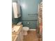 Well-lit bathroom with handicap bar, toilet, shower curtain, and linen cabinet at 1326 5Th Ne St, Hickory, NC 28601