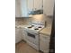 Kitchen featuring white range with overhead vent and white cabinetry at 1326 5Th Ne St, Hickory, NC 28601