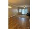 Spacious living room with elegant chandelier, neutral walls, and sliding glass door to the outside at 1326 5Th Ne St, Hickory, NC 28601