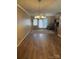 Spacious living room with elegant chandelier, neutral walls, and sliding glass door to the outside at 1326 5Th Ne St, Hickory, NC 28601
