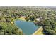 Beautiful aerial view of community lake surrounded by lush greenery and some houses at 14027 Springwater Dr, Matthews, NC 28105