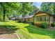 Well-manicured lawn and mature trees surround the home, providing a peaceful and picturesque backyard setting at 14027 Springwater Dr, Matthews, NC 28105