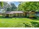 Charming home with a well-maintained lawn, lovely garden area, and a peaceful backyard at 14027 Springwater Dr, Matthews, NC 28105