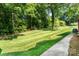 A spacious backyard features a lush lawn, mature trees, and offers a serene and private outdoor retreat at 14027 Springwater Dr, Matthews, NC 28105