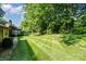 A spacious, manicured backyard offers serene views, mature trees, and a private outdoor setting at 14027 Springwater Dr, Matthews, NC 28105