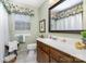 Bathroom with a vanity, a large mirror, and decorative curtains at 14027 Springwater Dr, Matthews, NC 28105