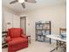 Bedroom features a ceiling fan, neutral paint, a comfortable reading chair, and convenient shelving for storage at 14027 Springwater Dr, Matthews, NC 28105