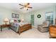 Bright bedroom with a wooden bed frame, colorful quilt, and chair at 14027 Springwater Dr, Matthews, NC 28105